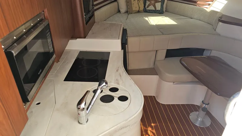 Slide: The Image of 2016 Grady-White Express 330 interior with kitchenette and seating area. - 36