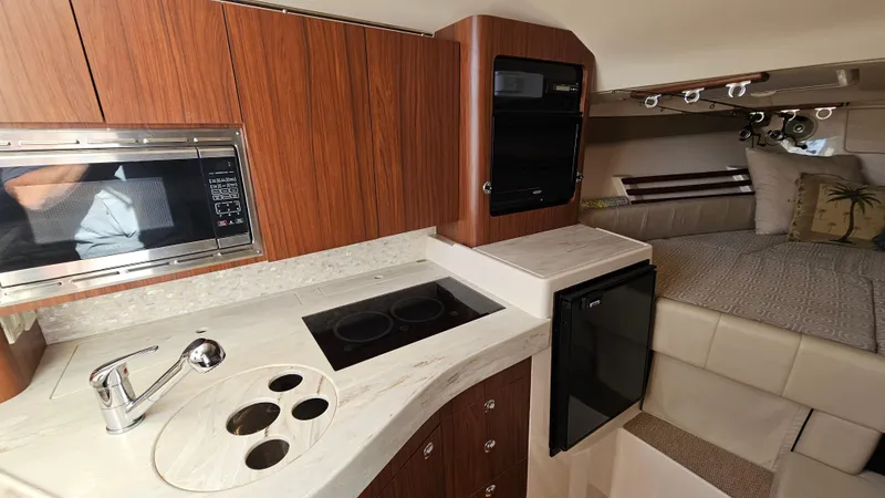 Slide: The Image of 2016 Grady-White Express 330 interior with kitchenette and cozy sleeping area. - 37