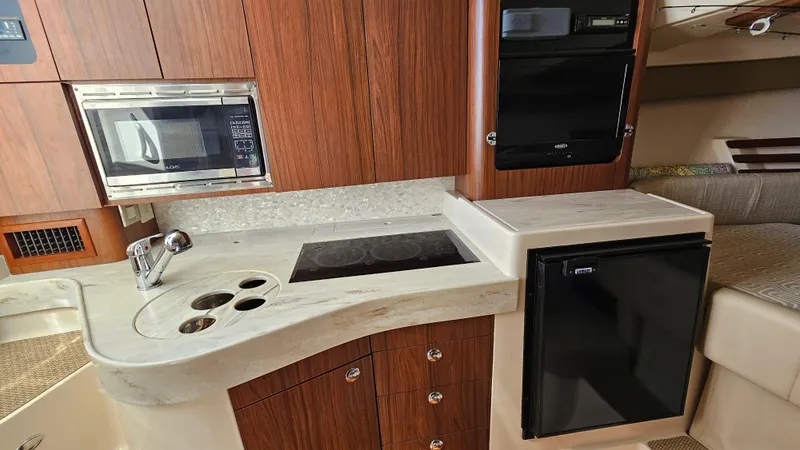Slide: The Image of 2016 Grady-White Express 330 boat kitchen with microwave, stove, and fridge. - 40