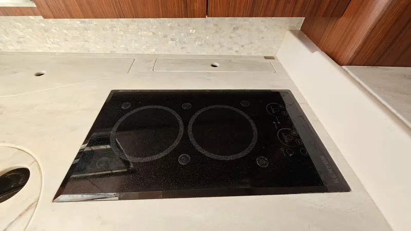 Slide: The Image of Built-in stovetop on 2016 Grady-White Express 330 yacht kitchen counter. - 42