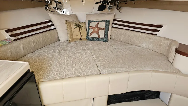 Slide: The Image of 2016 Grady-White Express 330 cabin interior with cozy bedding and decorative pillows. - 45