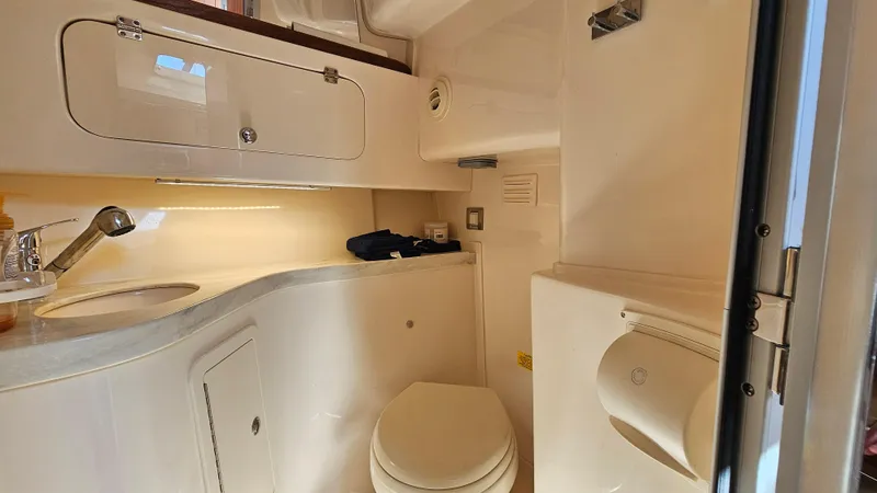Slide: The Image of 2016 Grady-White Express 330 boat bathroom with sink, toilet, and storage cabinets. - 48