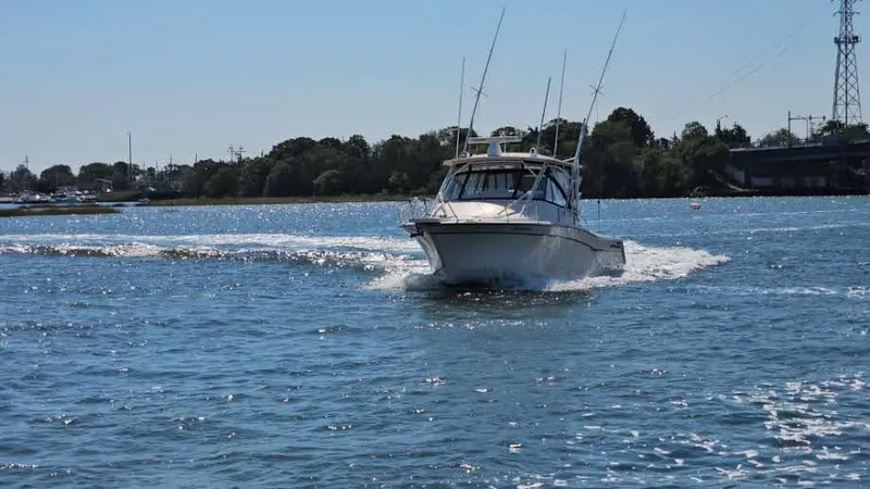 Slide: The Image of 2016 Grady-White Express 330 boat cruising on a sunny day. - 5