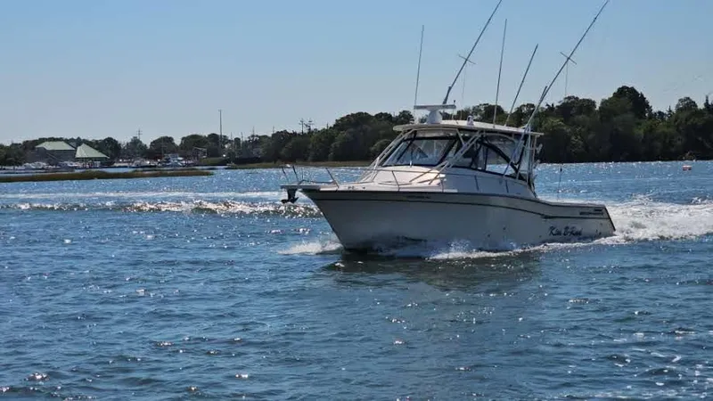 Slide: The Image of 2016 Grady-White Express 330 boat cruising on a sunny day in open water. - 6
