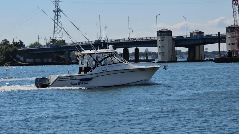 Slide: The Image of 2016 Grady-White Express 330 boat cruising near a bridge on a sunny day. - 7