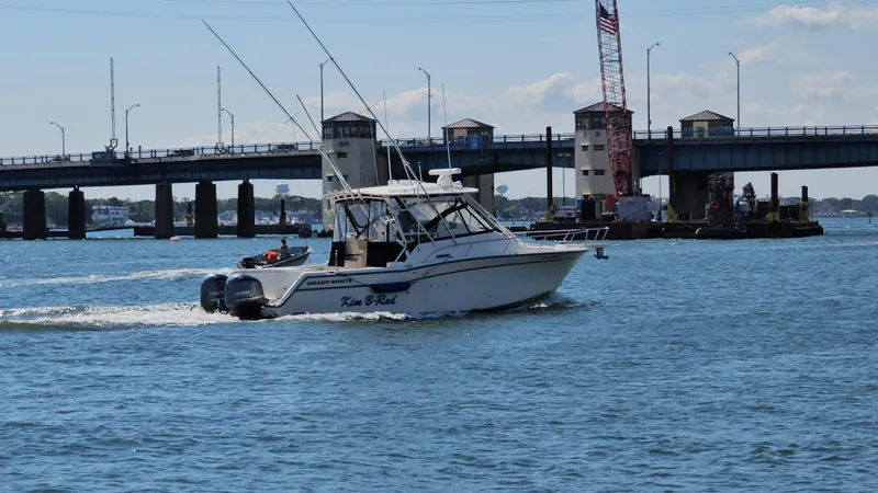 Slide: The Image of 2016 Grady-White Express 330 boat cruising near a bridge on a sunny day. - 8