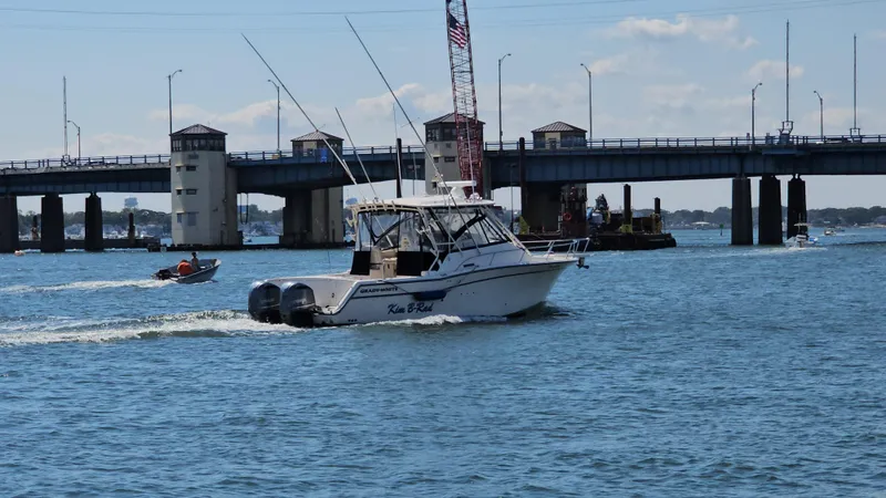 Slide: The Image of 2016 Grady-White Express 330 boat cruising near a bridge on a sunny day. - 9
