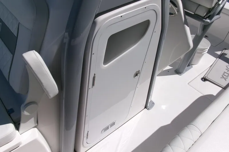 Slide: The Image of 2026 Sea Fox 268 Commander interior, featuring sleek white seating and storage compartment. - 14