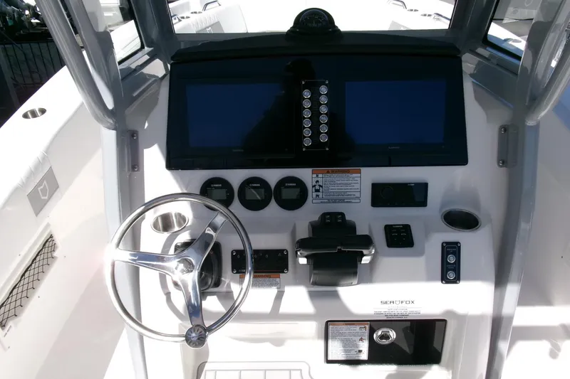 Slide: The Image of 2026 Sea Fox 268 Commander boat dashboard with steering wheel and control panel. - 16