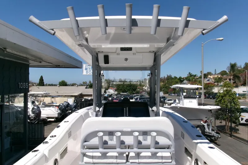 Slide: The Image of 2026 Sea Fox 268 Commander boat with T-top and rod holders, docked at a marina. - 18