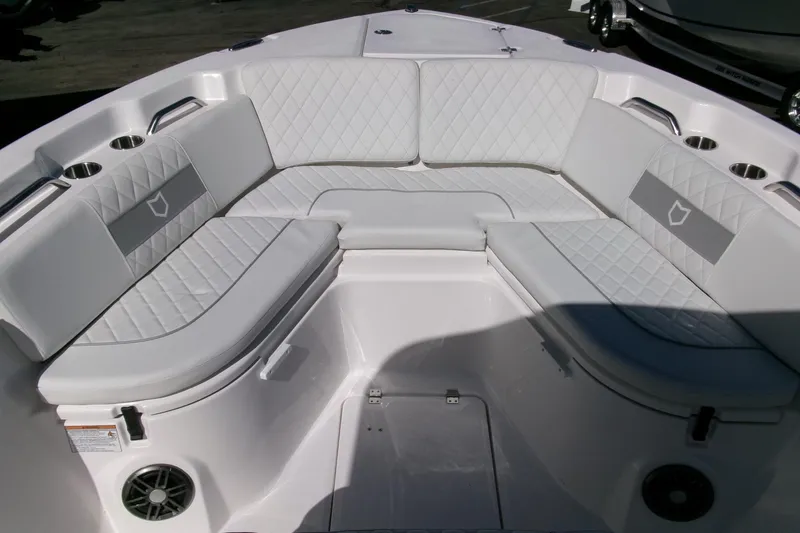 Slide: The Image of 2026 Sea Fox 268 Commander boat interior with white cushioned seating and cup holders. - 7