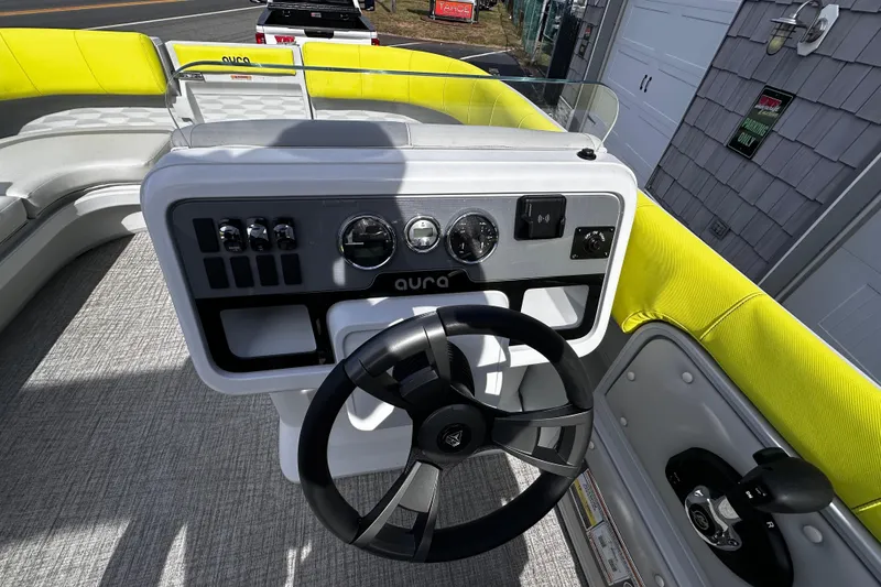 Slide: The Image of Steering console of 2025 Avalon 2185 Aura Quad Lounge boat with bright yellow seating. - 18