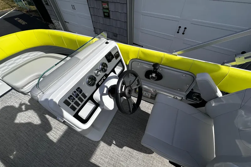 Slide: The Image of 2025 Avalon 2185 Aura Quad Lounge boat interior with modern helm and seating. - 21