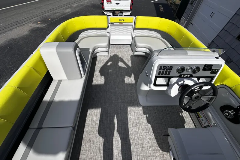 Slide: The Image of 2025 Avalon 2185 Aura Quad Lounge boat interior with modern seating and steering console. - 22