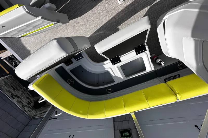 Slide: The Image of 2025 Avalon 2185 Aura Quad Lounge interior with modern seating and storage compartments. - 23