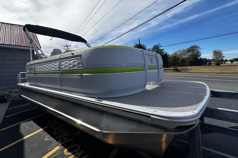 Slide: The Image of 2025 Avalon 2185 Aura Quad Lounge Twin Toon pontoon boat on trailer, side view. - 7