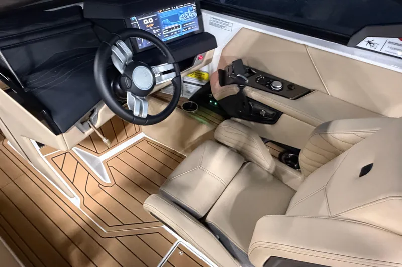 Slide: The Image of 2025 Nautique Super Air Nautique G23 cockpit with modern steering and control panel. - 10