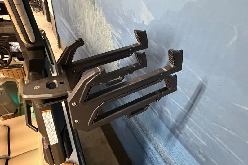 Slide: The Image of 2025 Nautique Super Air Nautique G23 wakeboard rack, mounted on a boat, against a blue background. - 13