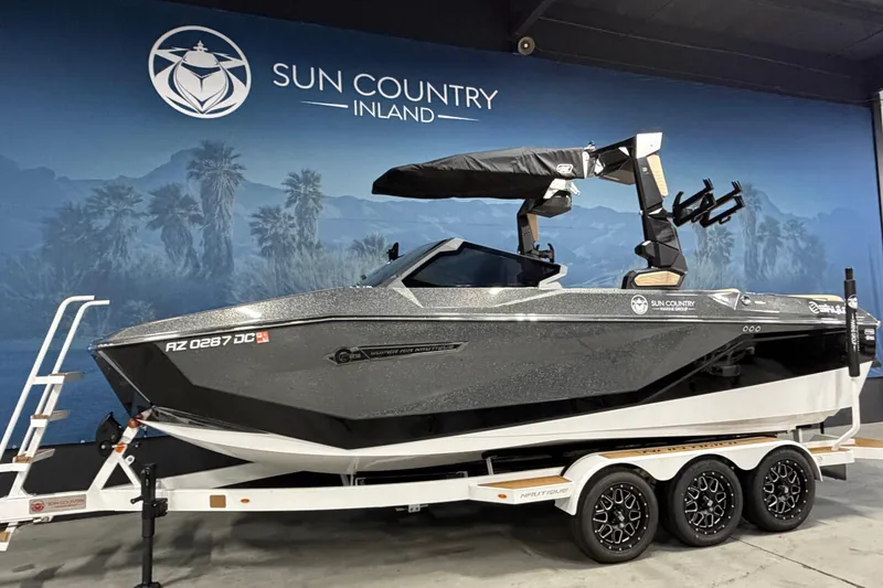 Slide: The Image of 2025 Nautique Super Air Nautique G23 boat on trailer at Sun Country Inland showroom. - 2