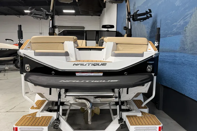 Slide: The Image of 2025 Nautique Super Air Nautique G23 boat, rear view in showroom setting. - 3