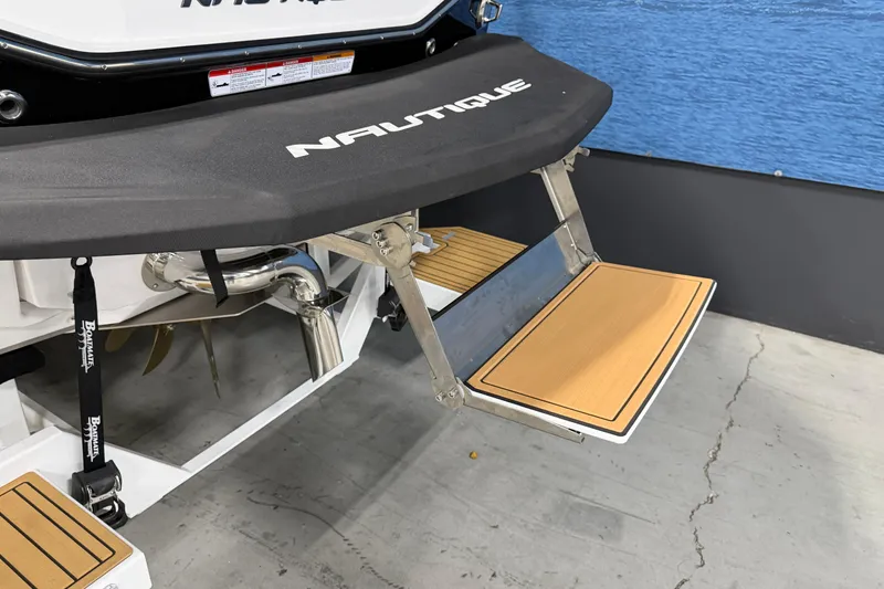 Slide: The Image of 2025 Nautique Super Air Nautique G23 swim platform with teak steps, displayed indoors. - 5