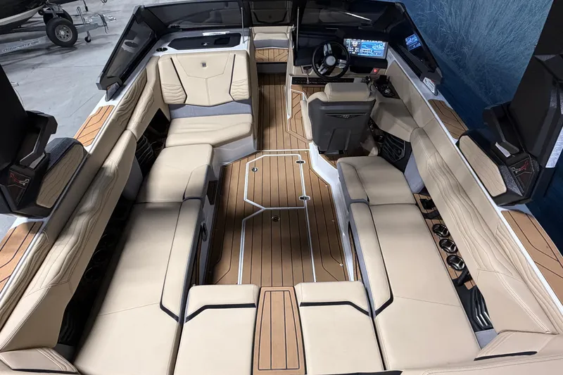 Slide: The Image of 2025 Nautique Super Air Nautique G23 interior with luxurious seating and advanced dashboard. - 7