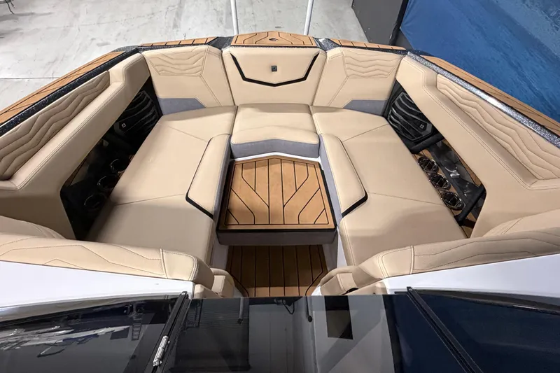 Slide: The Image of Luxurious interior of 2025 Nautique Super Air Nautique G23 boat with beige seating and wood accents. - 8