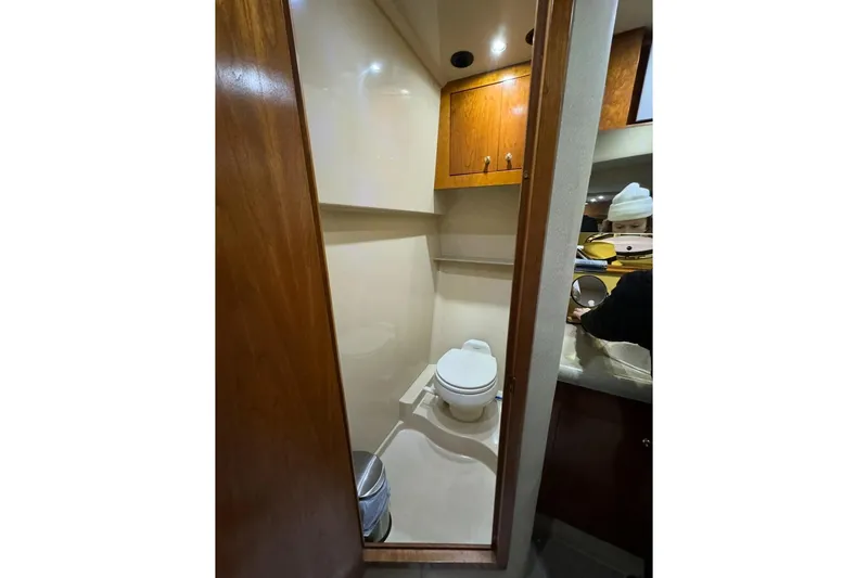 Slide: The Image of 2003 Cruisers Yachts 4370 Express bathroom with wooden cabinets and modern fixtures. - 20