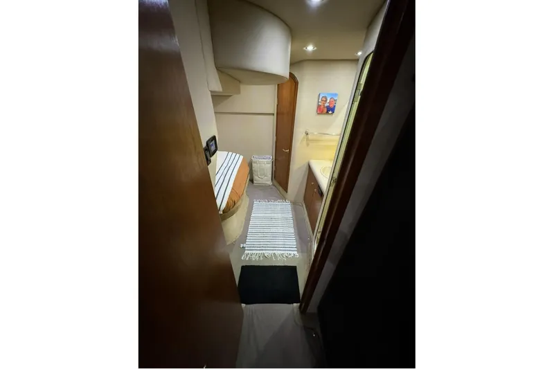 Slide: The Image of Interior of 2003 Cruisers Yachts 4370 Express, featuring cozy cabin and bathroom. - 22