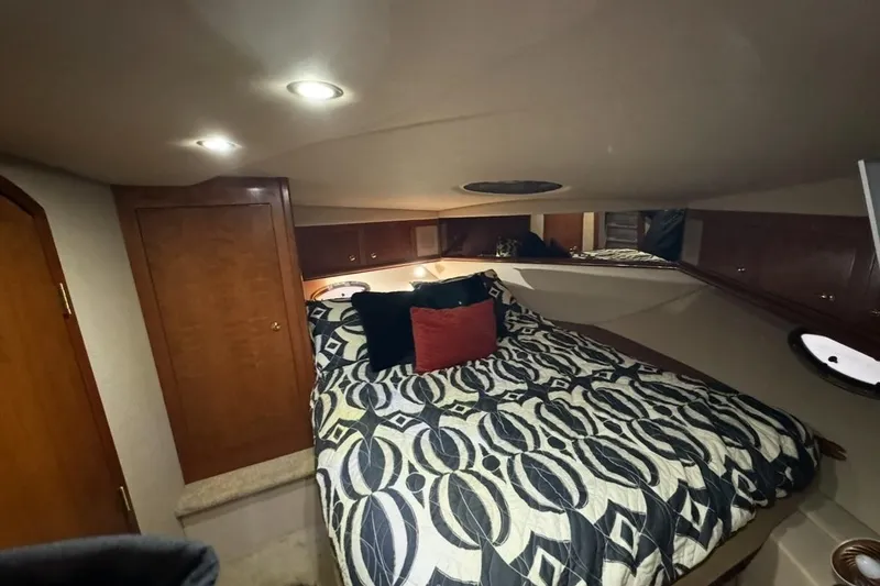 Slide: The Image of Luxurious cabin interior of 2003 Cruisers Yachts 4370 Express with patterned bedding. - 23