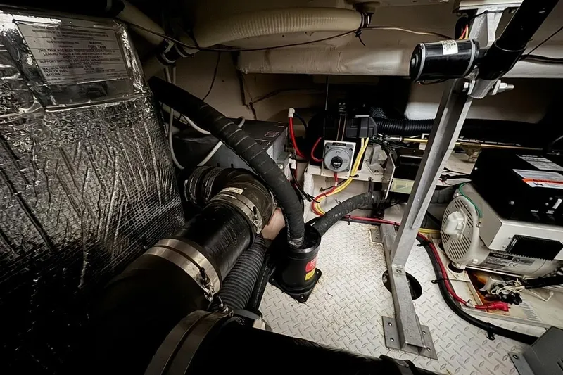 Slide: The Image of Engine room of 2003 Cruisers Yachts 4370 Express with visible machinery and wiring. - 29