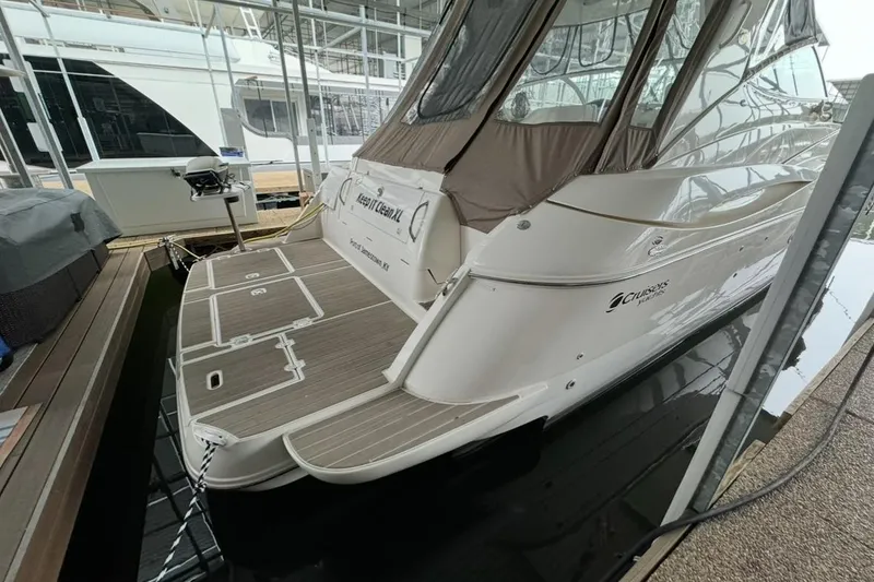 Slide: The Image of 2003 Cruisers Yachts 4370 Express docked in a marina, rear view. - 7