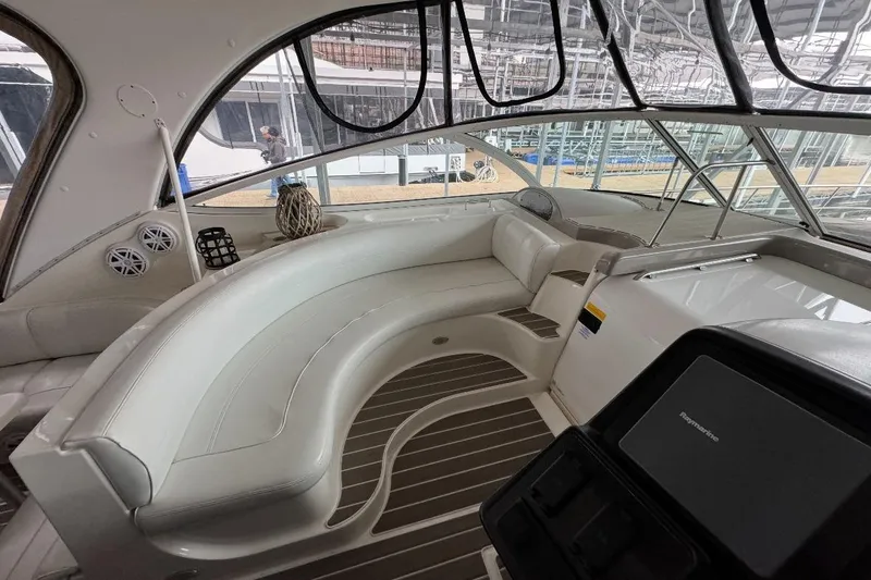 Slide: The Image of 2003 Cruisers Yachts 4370 Express interior with curved seating and modern dashboard. - 8