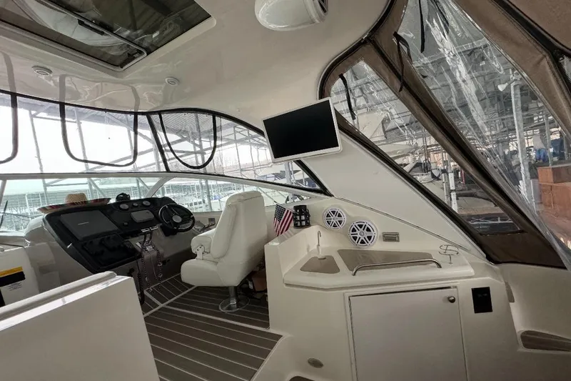 Slide: The Image of Interior of 2003 Cruisers Yachts 4370 Express with helm, seating, and modern amenities. - 9