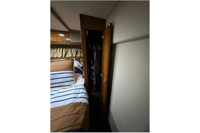 Slide: The Image of Interior of 2003 Cruisers Yachts 4370 Express with bed and closet. - 17