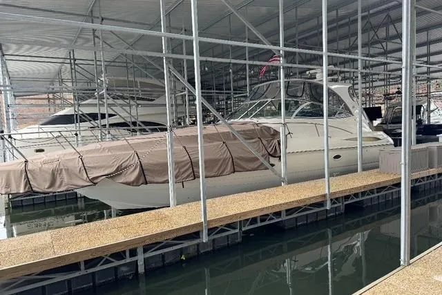 Slide: The Image of 2003 Cruisers Yachts 4370 Express docked in covered marina. - 2