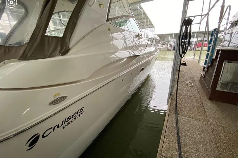Slide: The Image of 2003 Cruisers Yachts 4370 Express docked in a marina, side view. - 3