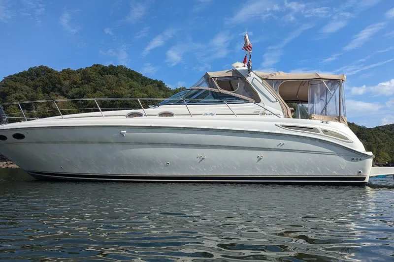 The Image of 2000 Sea Ray 380 Sundancer yacht on calm water with scenic forested background. - 0