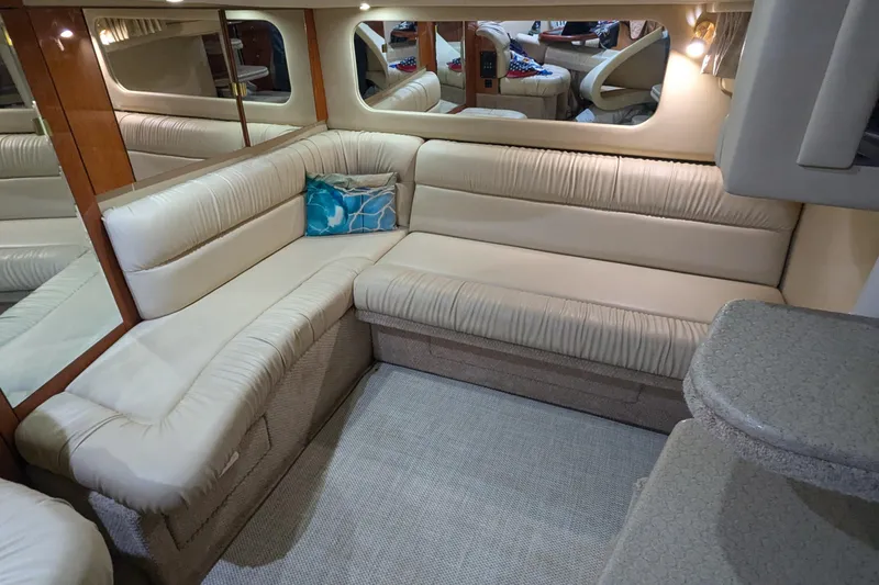 Slide: The Image of Luxurious interior of 2000 Sea Ray 380 Sundancer with cream leather seating and decorative pillows. - 13