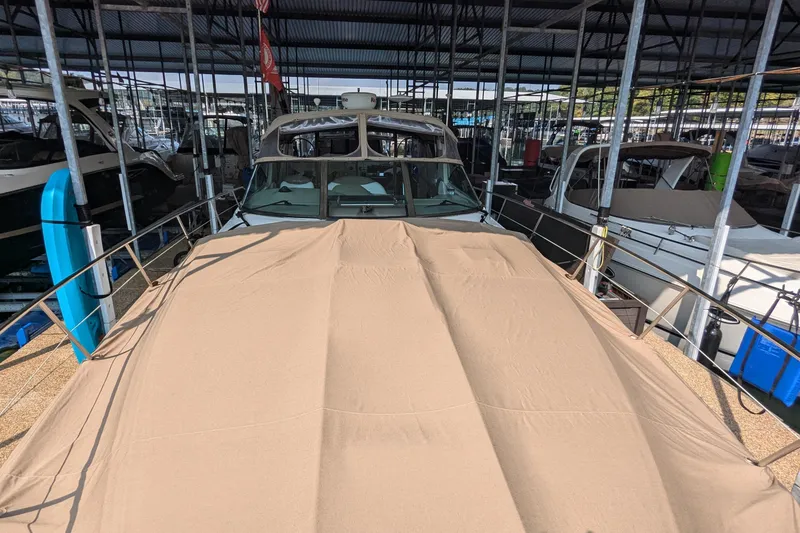 Slide: The Image of 2000 Sea Ray 380 Sundancer covered in a marina, surrounded by other boats. - 17