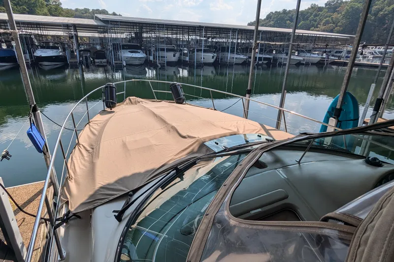 Slide: The Image of Sea Ray 380 Sundancer 2000 docked at marina with covered deck and surrounding boats. - 2