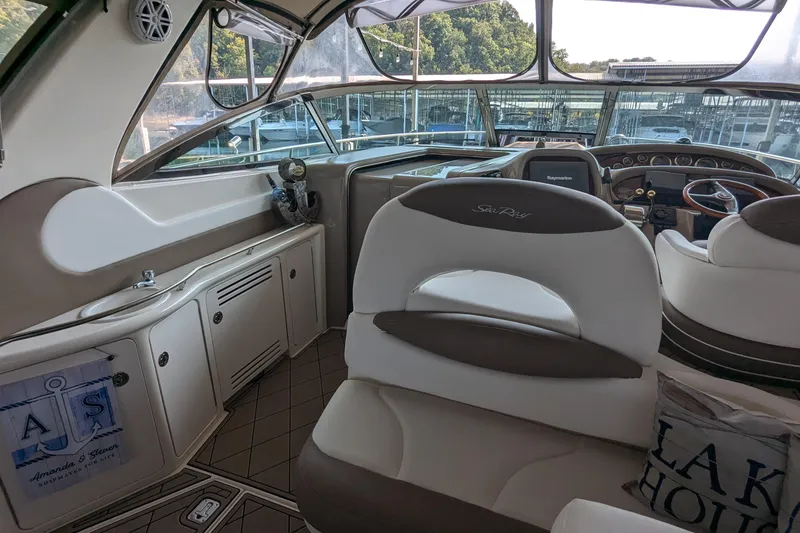 Slide: The Image of Interior of a 2000 Sea Ray 380 Sundancer yacht with helm and seating area. - 23