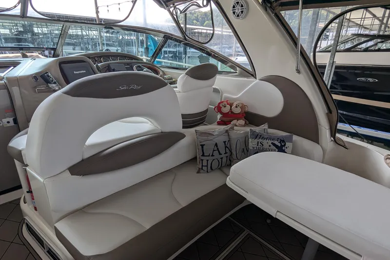 Slide: The Image of Interior of a 2000 Sea Ray 380 Sundancer with plush seating and decorative pillows. - 24