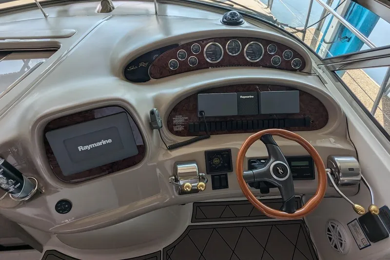 Slide: The Image of Helm of 2000 Sea Ray 380 Sundancer with Raymarine navigation system and wood-accented steering wheel. - 4