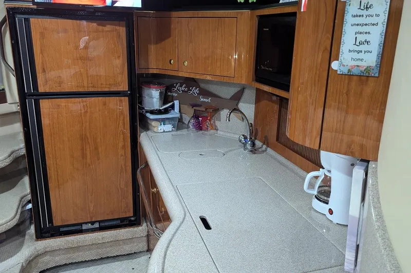 Slide: The Image of Interior of 2000 Sea Ray 380 Sundancer yacht kitchen with wood cabinets and appliances. - 8