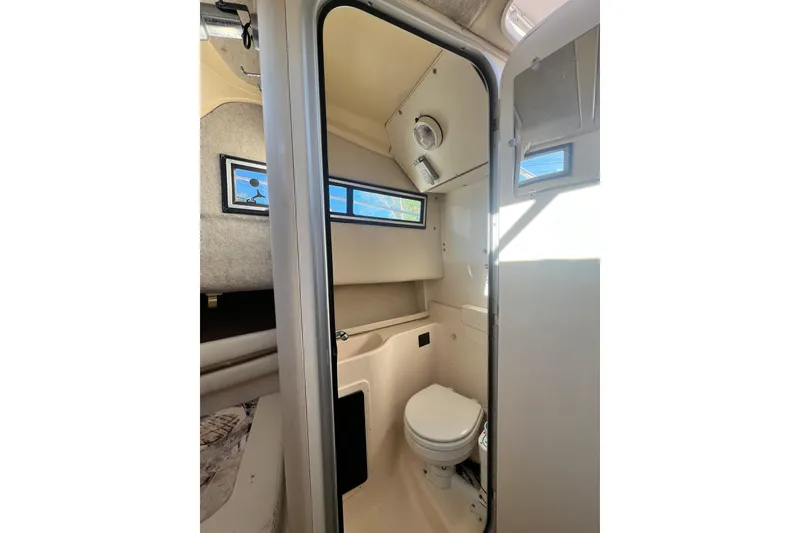 Slide: The Image of 1999 Grady-White Islander 268 boat interior with compact bathroom and window. - 12