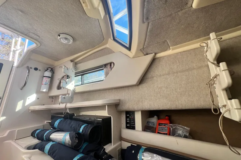 Slide: The Image of 1999 Grady-White Islander 268 cabin interior with storage and safety equipment. - 14