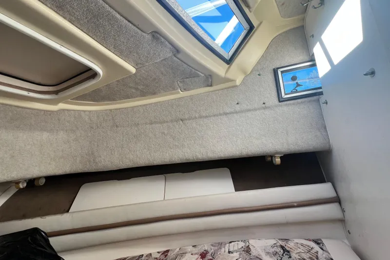 Slide: The Image of Interior cabin of 1999 Grady-White Islander 268 boat with windows and seating. - 15
