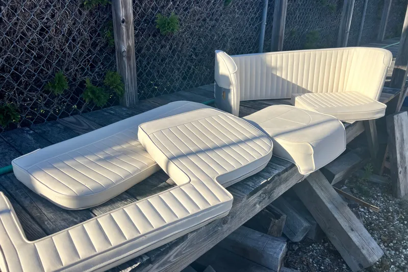 Slide: The Image of White boat cushions for 1999 Grady-White Islander 268 on wooden surface. - 16