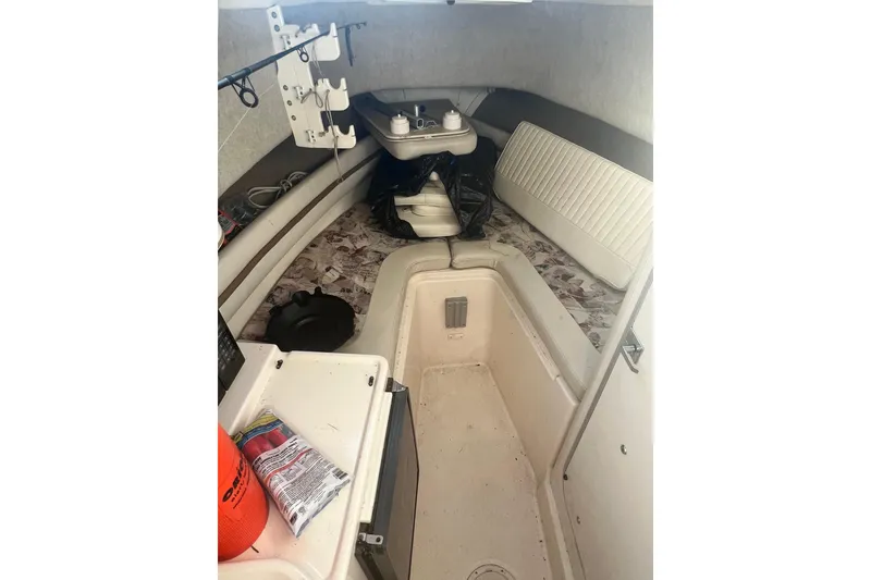 Slide: The Image of 1999 Grady-White Islander 268 cabin interior with seating and fishing gear. - 21